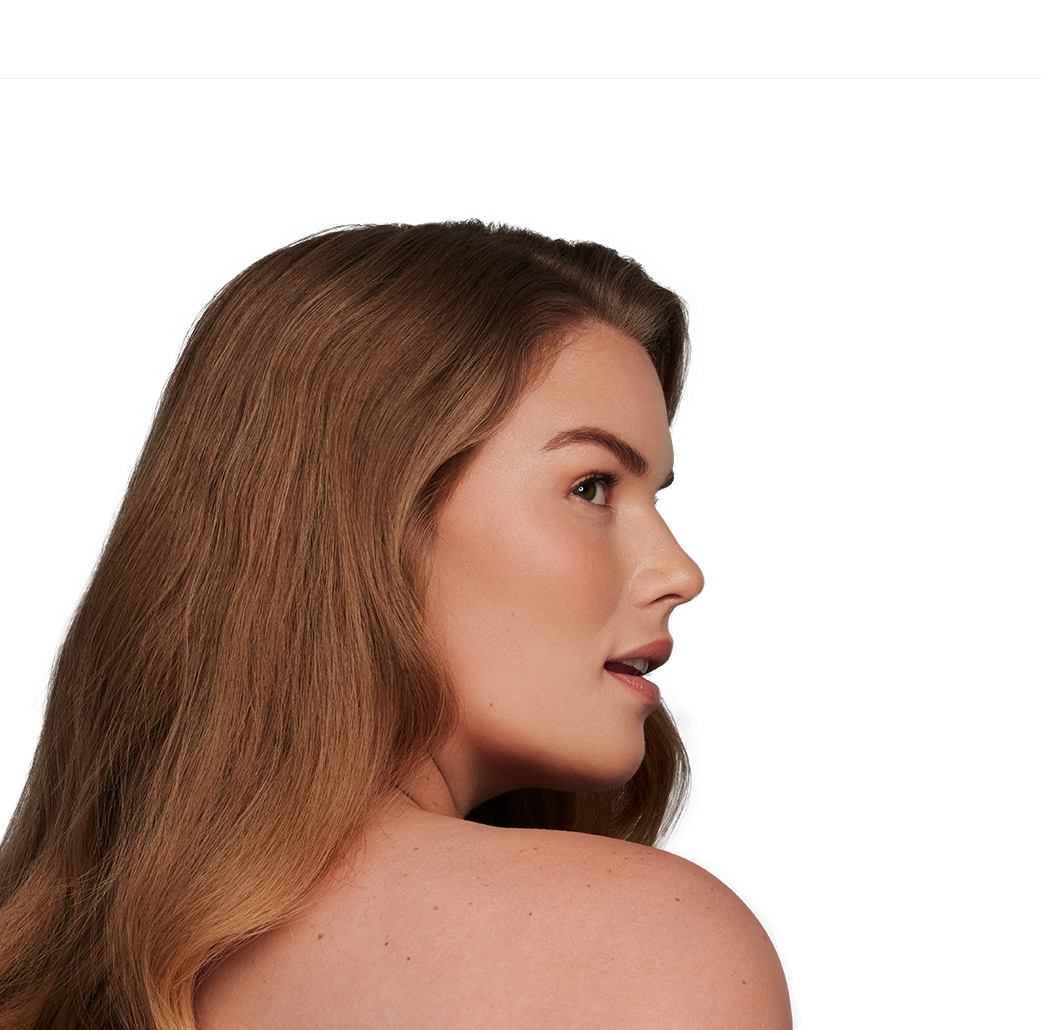 Woman looking over her shoulder with clear skin